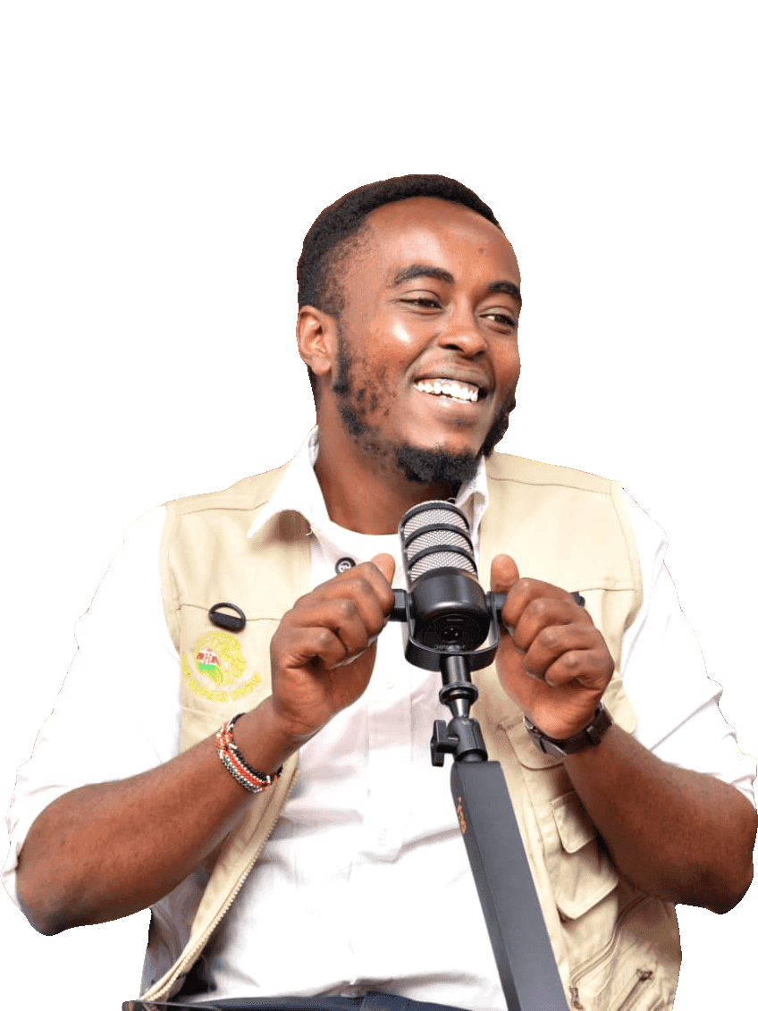 Denzel Maina smiling, in a white shirt and beige vest, holding a podcast microphone